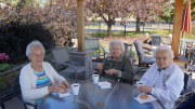 Residents eating cookies around patio table.JPG